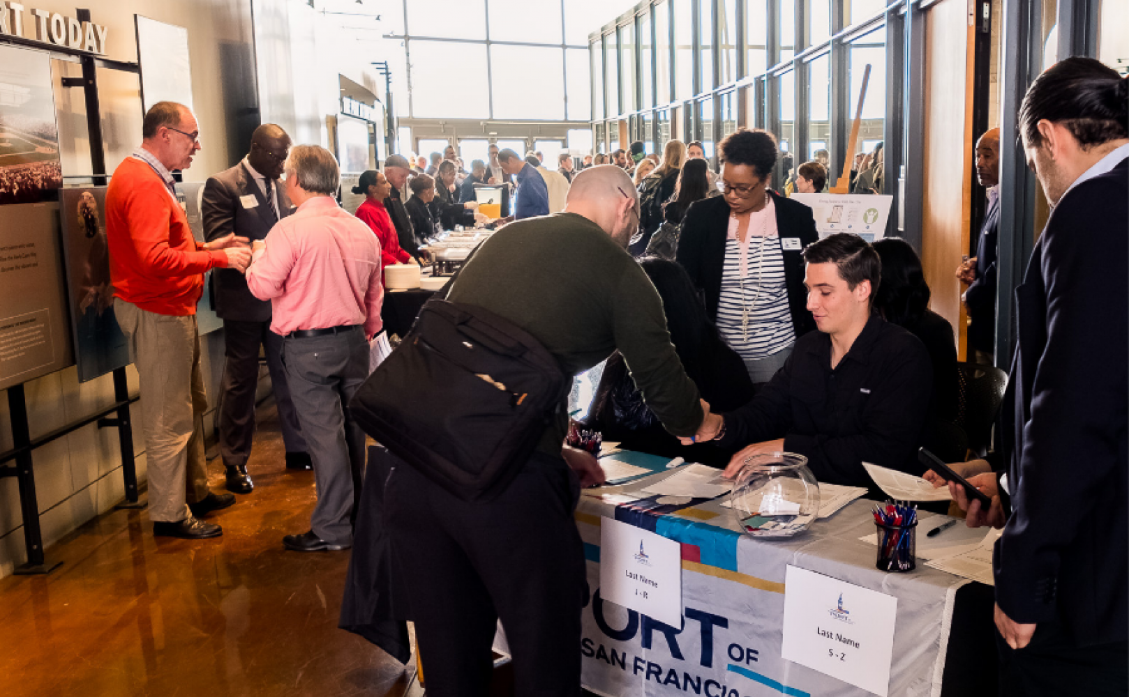 People signing in at a meeting