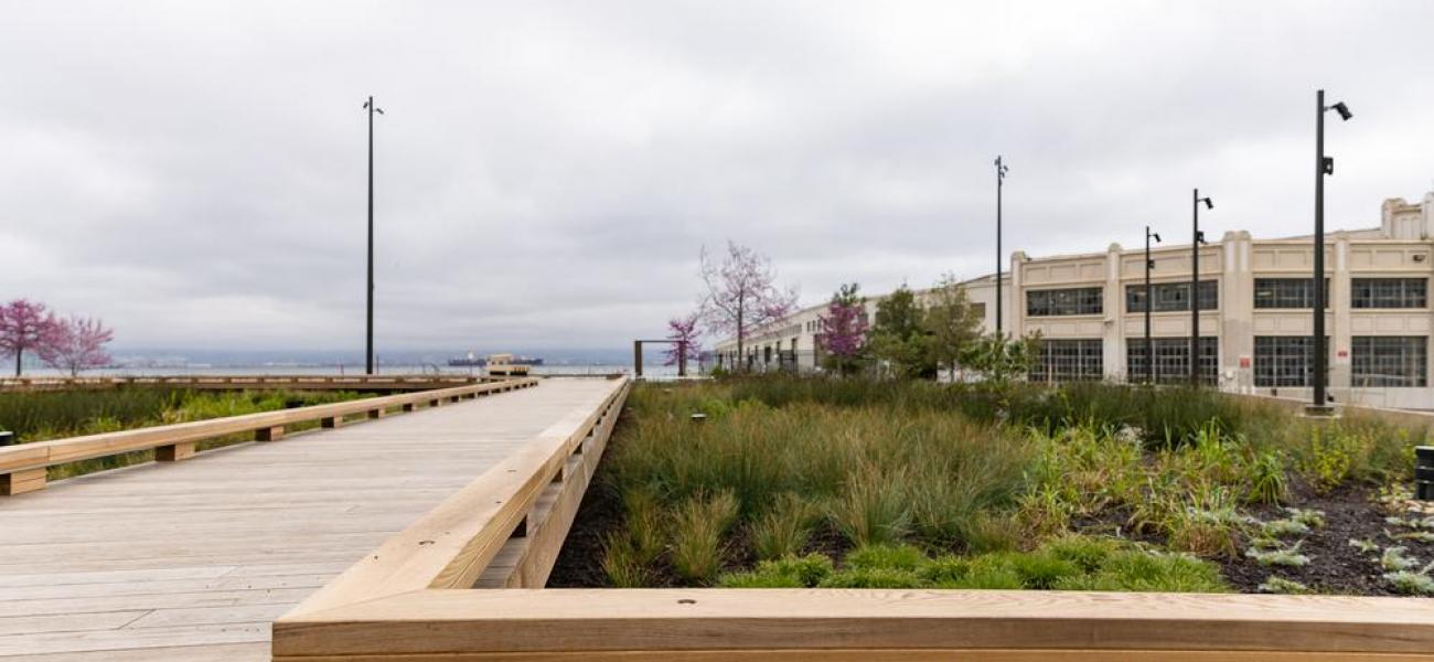 Wooden walkway leads to paved pathway around China Basin Park
