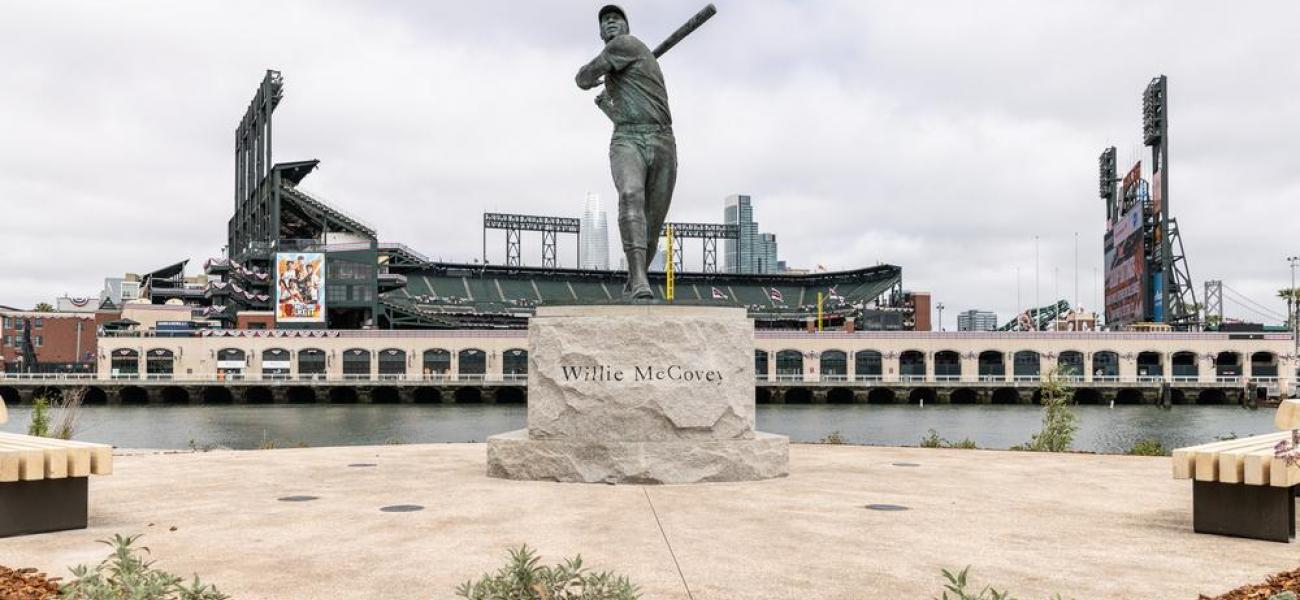 Statue of Willie Mays stands with a view of the ballpark at China Basin Park