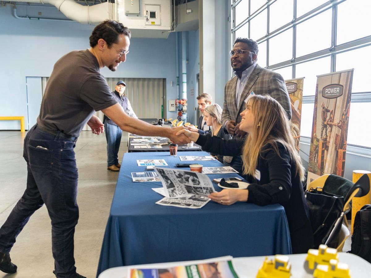 A vendor meets with a contractor in the exhibitor hall at the Port's Contract Open House.