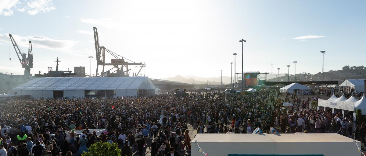Shipping cranes tower over thousands of people attending Portola Festival at Pier 80.