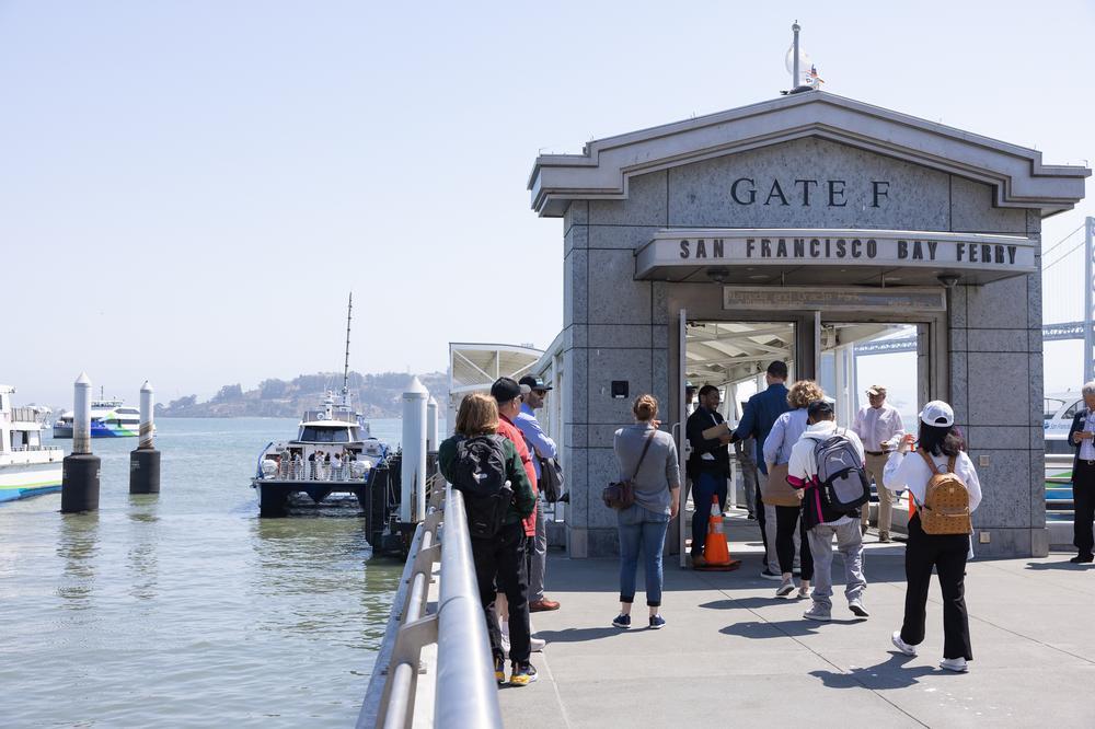 Ferry riders queue at Gate F before boarding Sea Change, the first hydrogen-powered ferry in SF Bay Ferry's fleet.
