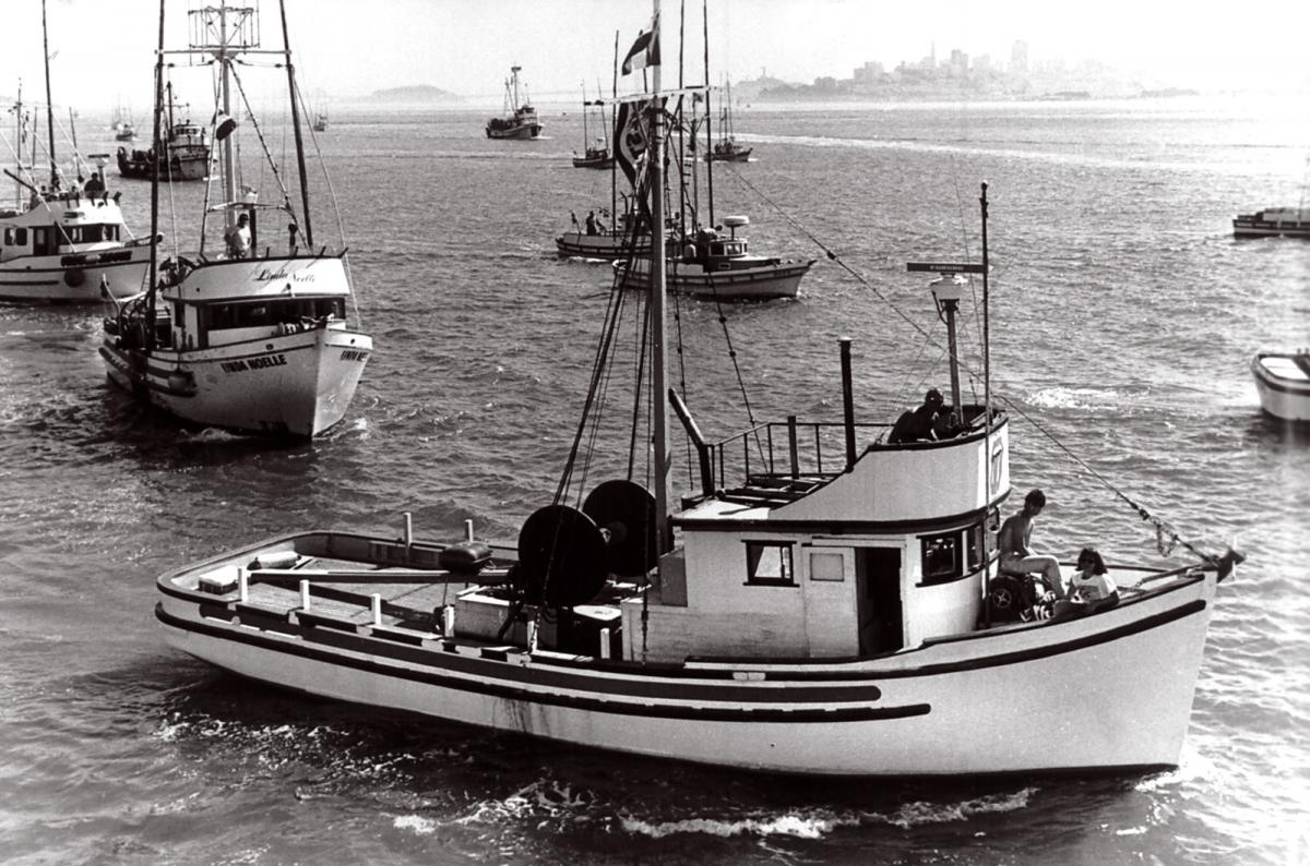 Historic&nbsp;image&nbsp;of&nbsp;a&nbsp;boat&nbsp;procession&nbsp;at&nbsp;sea.&nbsp;