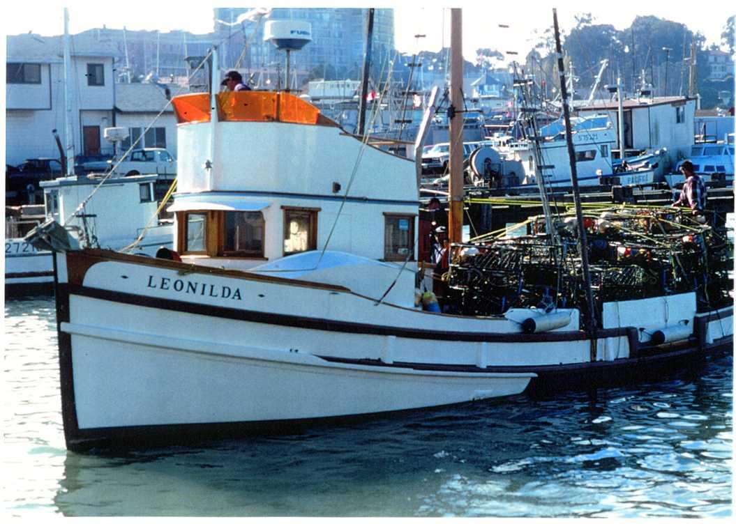 Fishing boat outfitted for crabbing, with pots.