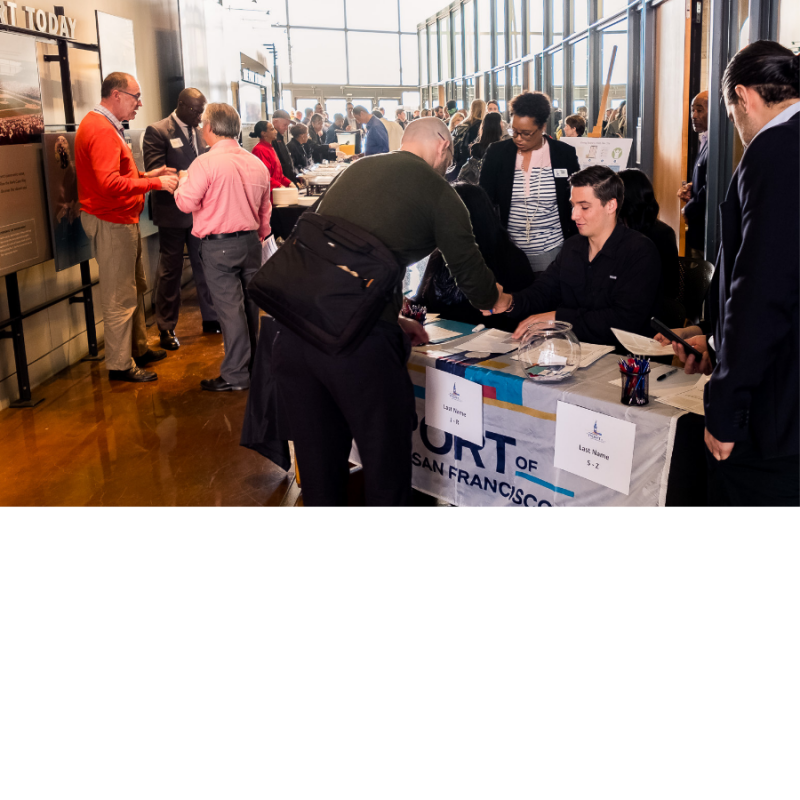 People signing in at a meeting